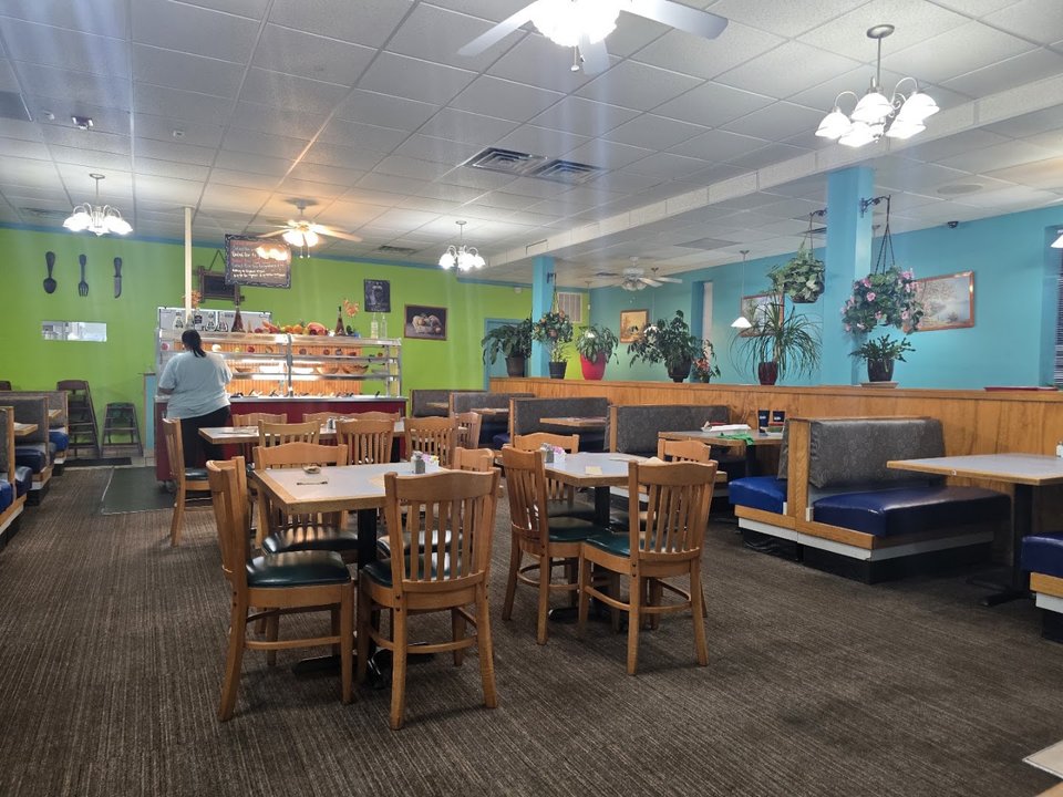 Cozy family restaurant dining room with simple tables.